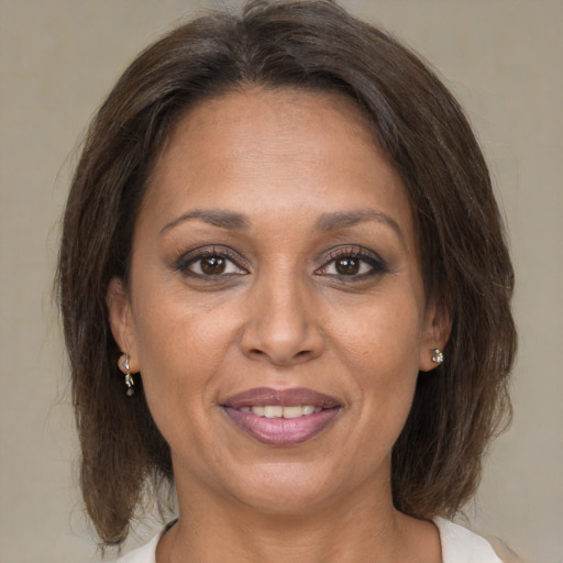 Joyful white adult female with medium  brown hair and brown eyes