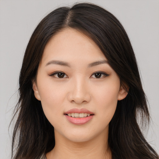 Joyful asian young-adult female with long  brown hair and brown eyes