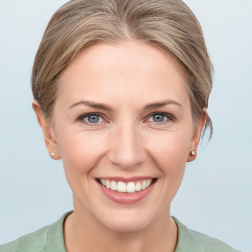 Joyful white young-adult female with medium  brown hair and grey eyes