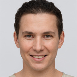 Joyful white adult male with short  brown hair and brown eyes