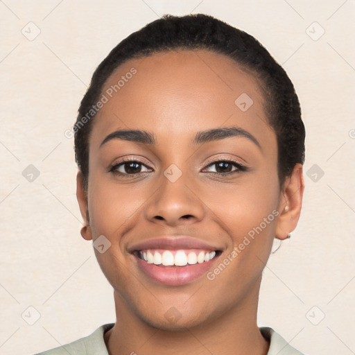 Joyful latino young-adult female with short  black hair and brown eyes