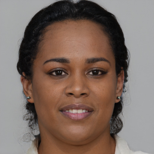 Joyful black young-adult female with medium  brown hair and brown eyes