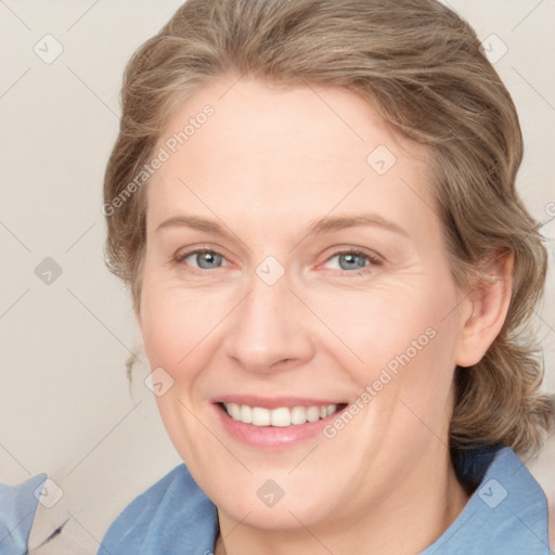 Joyful white adult female with medium  brown hair and blue eyes