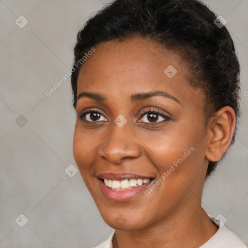 Joyful black young-adult female with short  black hair and brown eyes