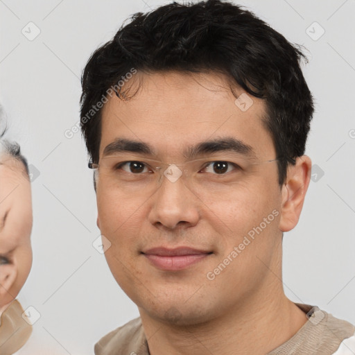 Joyful white young-adult male with short  black hair and brown eyes