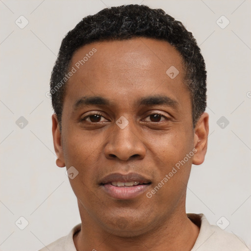 Joyful black young-adult male with short  black hair and brown eyes