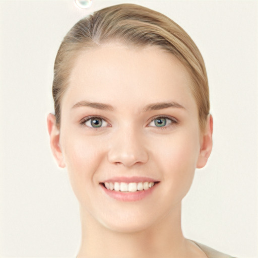 Joyful white young-adult female with short  brown hair and blue eyes