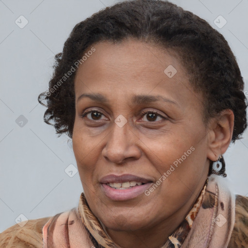 Joyful latino adult female with medium  brown hair and brown eyes