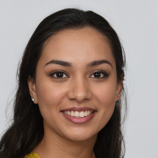 Joyful white young-adult female with long  brown hair and brown eyes