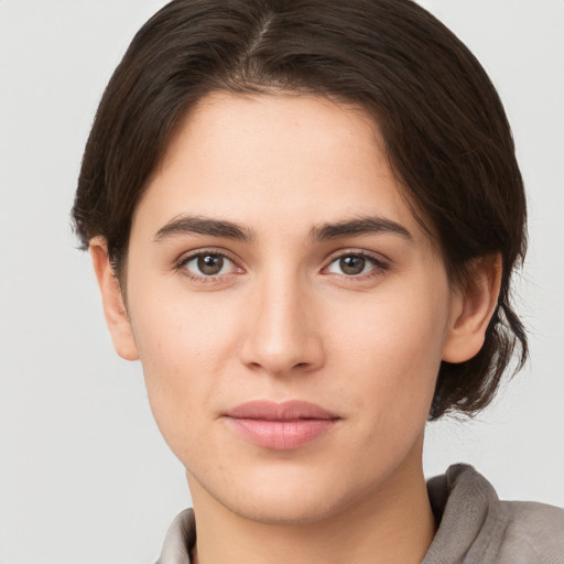 Neutral white young-adult female with short  brown hair and brown eyes