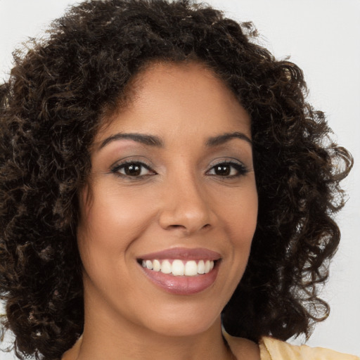 Joyful latino young-adult female with long  brown hair and brown eyes