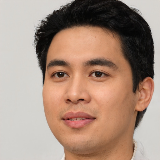 Joyful asian young-adult male with short  black hair and brown eyes