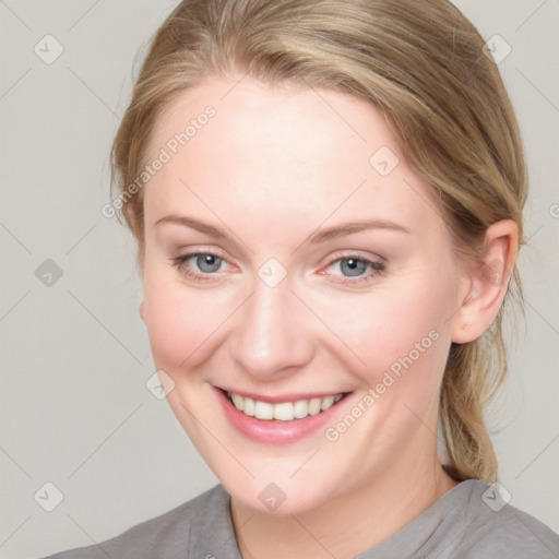 Joyful white young-adult female with medium  brown hair and blue eyes