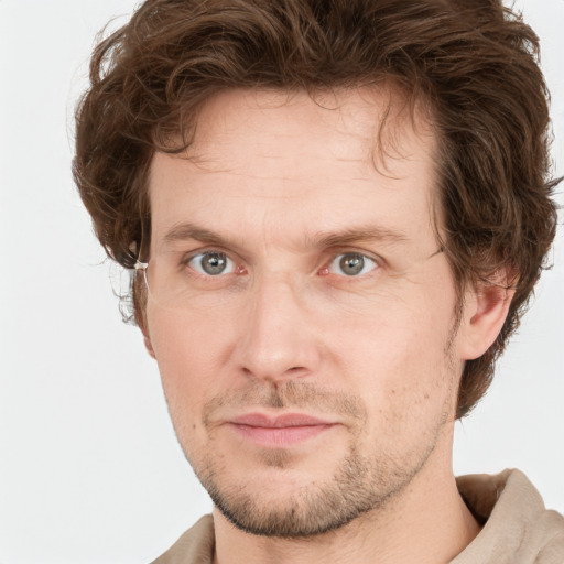 Joyful white adult male with short  brown hair and grey eyes