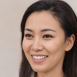 Joyful asian young-adult female with long  brown hair and brown eyes