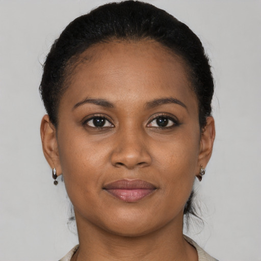 Joyful black young-adult female with short  brown hair and brown eyes