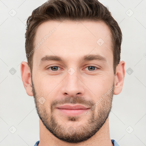 Joyful white young-adult male with short  brown hair and grey eyes