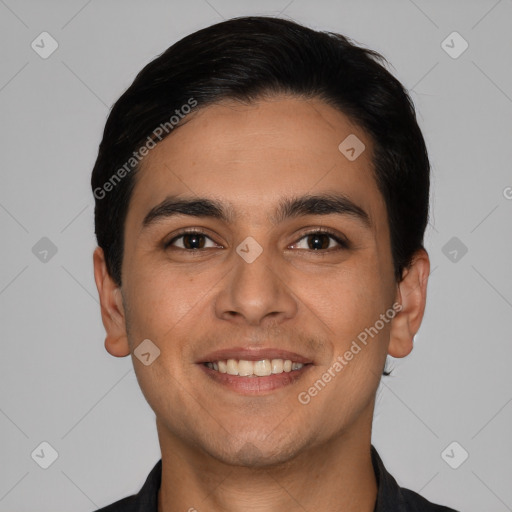 Joyful white young-adult male with short  black hair and brown eyes