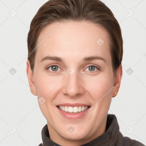 Joyful white young-adult female with short  brown hair and grey eyes