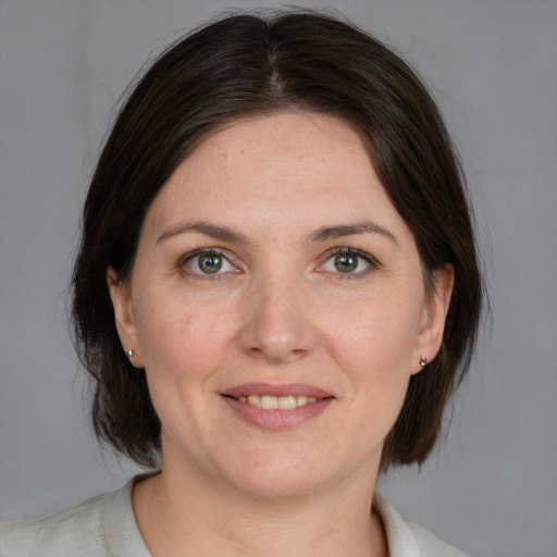 Joyful white adult female with medium  brown hair and brown eyes