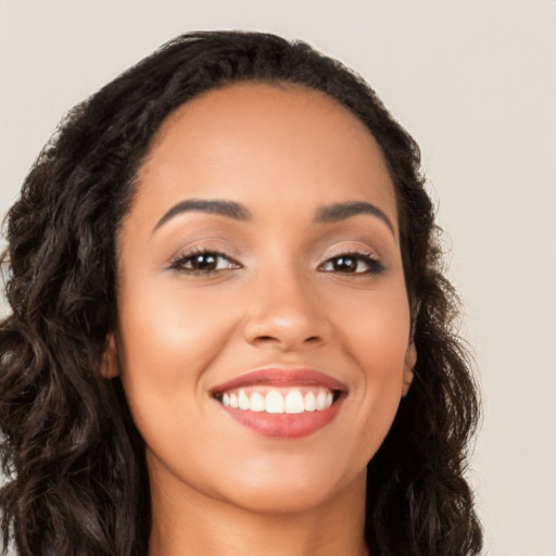 Joyful latino young-adult female with long  black hair and brown eyes