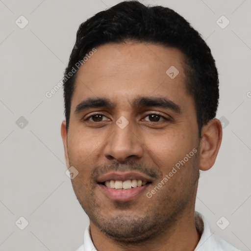 Joyful latino young-adult male with short  black hair and brown eyes