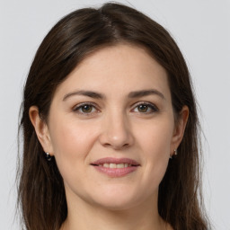 Joyful white young-adult female with long  brown hair and grey eyes