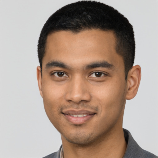 Joyful latino young-adult male with short  brown hair and brown eyes