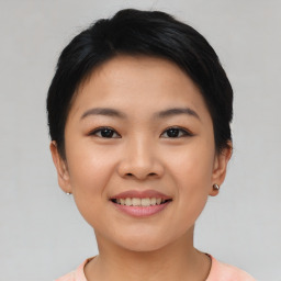 Joyful asian young-adult female with short  black hair and brown eyes