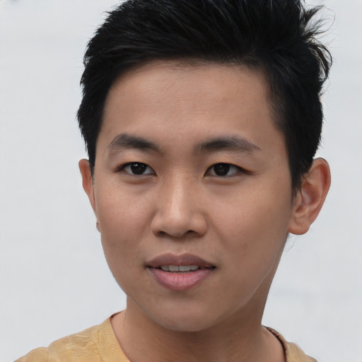 Joyful asian young-adult male with short  brown hair and brown eyes