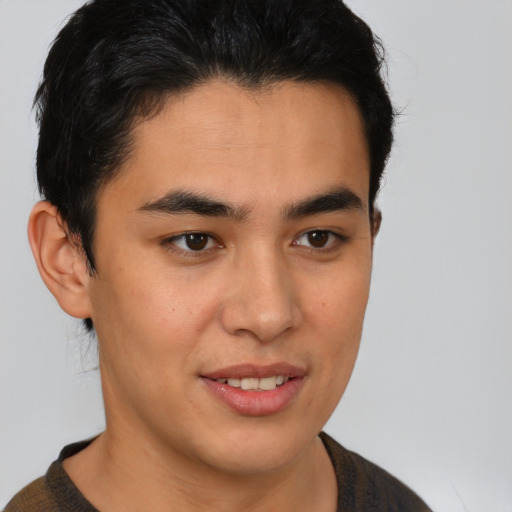 Joyful latino young-adult male with short  brown hair and brown eyes