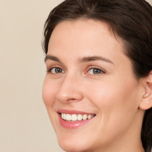 Joyful white young-adult female with medium  brown hair and brown eyes