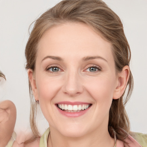 Joyful white young-adult female with medium  brown hair and blue eyes