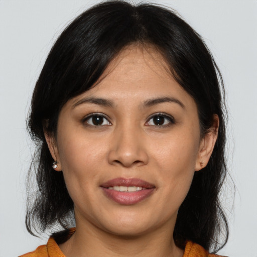 Joyful asian young-adult female with medium  brown hair and brown eyes