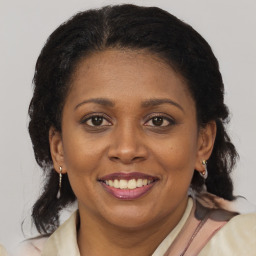 Joyful latino adult female with medium  brown hair and brown eyes