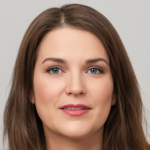 Joyful white young-adult female with long  brown hair and brown eyes