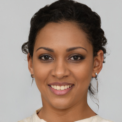 Joyful latino young-adult female with short  black hair and brown eyes