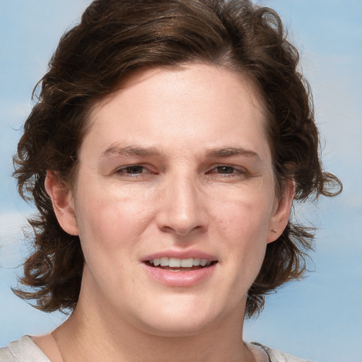 Joyful white adult female with medium  brown hair and grey eyes