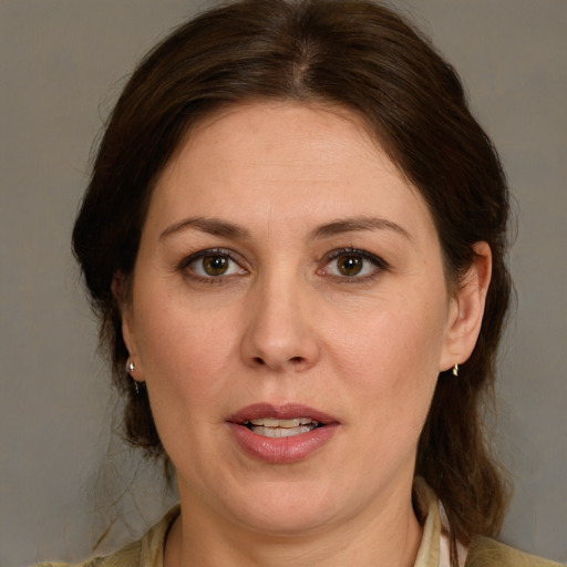 Joyful white adult female with medium  brown hair and brown eyes