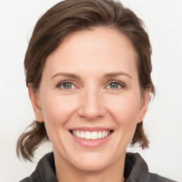 Joyful white adult female with medium  brown hair and grey eyes