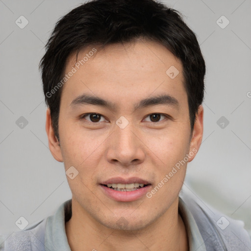 Joyful asian young-adult male with short  brown hair and brown eyes