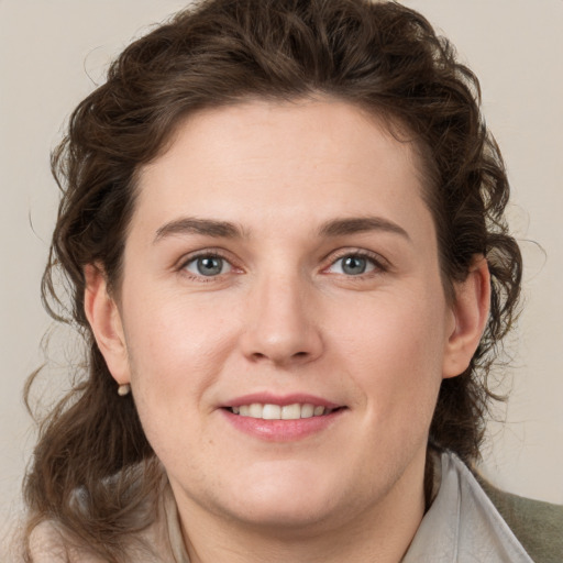 Joyful white young-adult female with medium  brown hair and green eyes