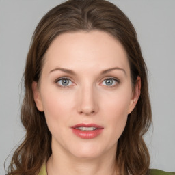 Joyful white young-adult female with medium  brown hair and green eyes