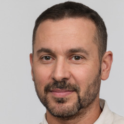 Joyful white adult male with short  brown hair and brown eyes