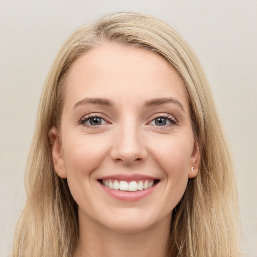 Joyful white young-adult female with long  brown hair and blue eyes