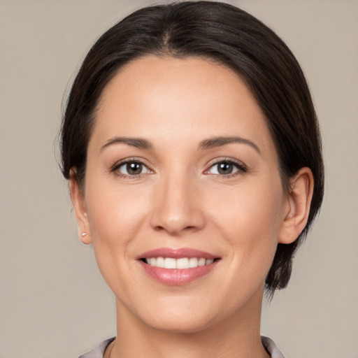 Joyful white young-adult female with medium  brown hair and brown eyes