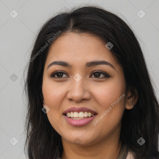 Joyful latino young-adult female with long  brown hair and brown eyes