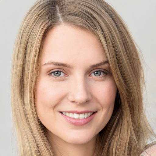 Joyful white young-adult female with long  brown hair and grey eyes