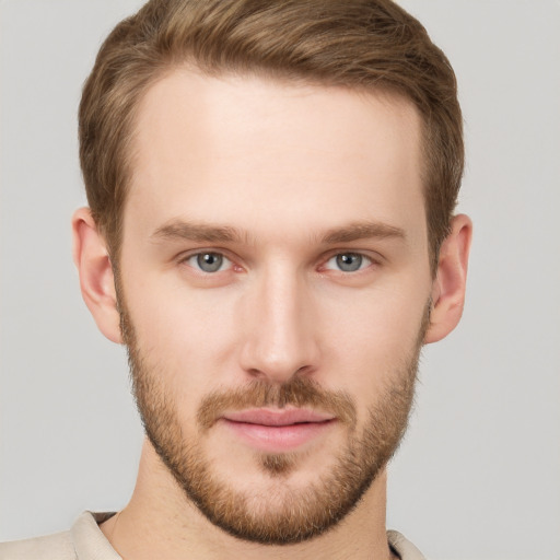 Joyful white young-adult male with short  brown hair and grey eyes