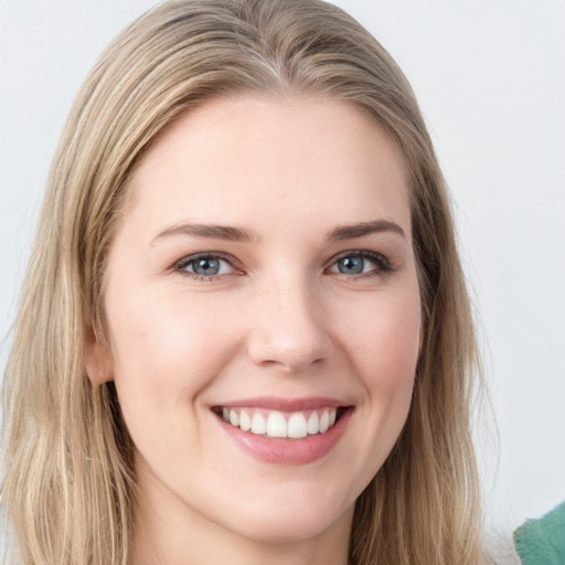 Joyful white young-adult female with long  brown hair and blue eyes